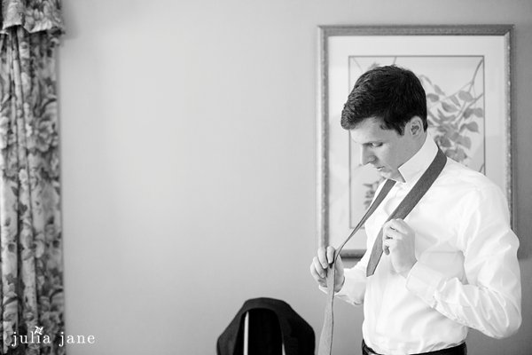 groom getting ready at the water's edge in westbrook, ct