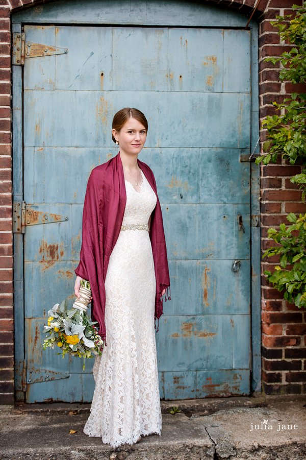 bride in front of the blue door at the lace factory 